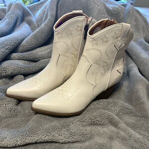 Woman’s ankle, cowboy boots- white